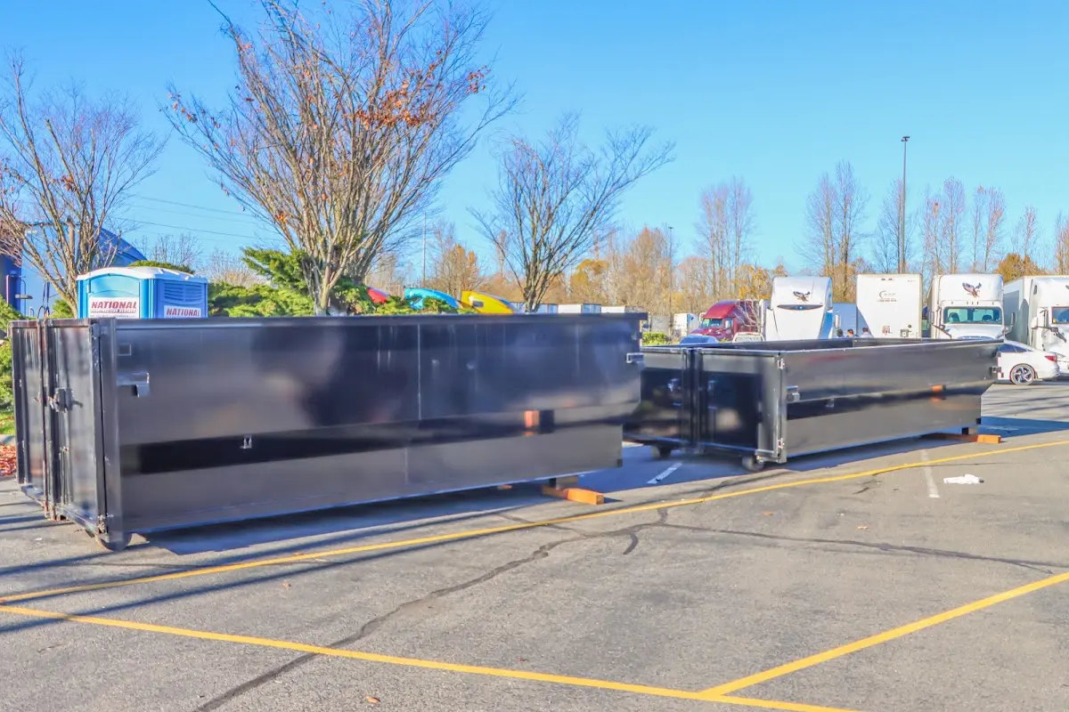 Professional dumpster rental service with roll-off container on residential driveway in Palmerton